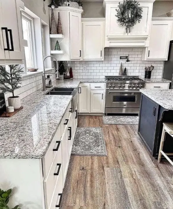 White kitchen with subway tile, granite counters and navy island